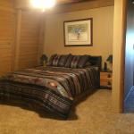Knotty pine walls and ceiling with open beams.