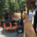 Forklift delivers refrigerator to stairs.